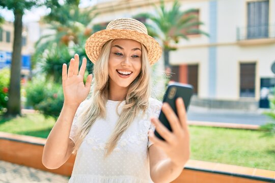 Young caucasian tourist girl doing video call using smartphone at city.