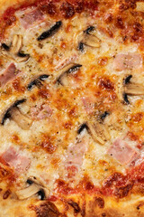 Homemade pizza with champignon mushrooms and ham
