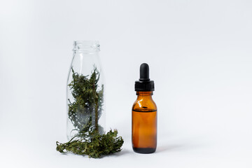 Close up shot of cannabis flower and cannabis oil bottle