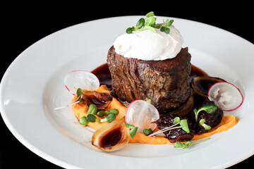 Steak with poached egg, sweet potato and mushroom sauce.