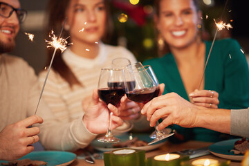 Group of friends celebrating Christmas and drinking wine