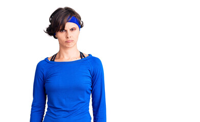 Beautiful young woman with short hair wearing training workout clothes depressed and worry for distress, crying angry and afraid. sad expression.