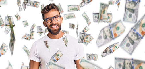 Young hispanic man wearing casual clothes and glasses winking looking at the camera with sexy...