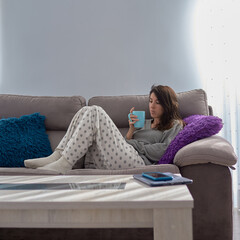 Woman at home with a cup of coffee