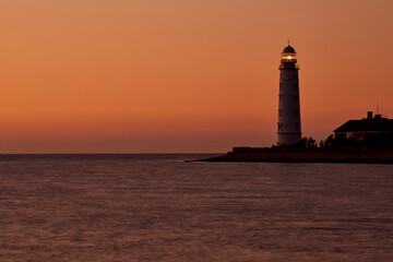 beautiful tall white lighthouse at sunset Crimea peninsula Cape Fiolent