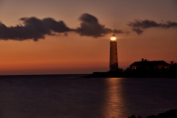 beautiful tall white lighthouse at sunset Crimea peninsula Cape Fiolent
