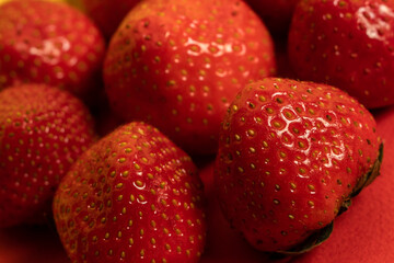 Background of fresh and ripe strawberries. Closeup, selective focus.