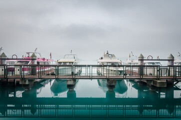 Fototapeta premium Boat at pier in misty sun rise at Sun Moon lake, Taiwan