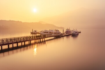 Beautiful sun rise scene of boats at pier at Sun Moon Lake, Taiw