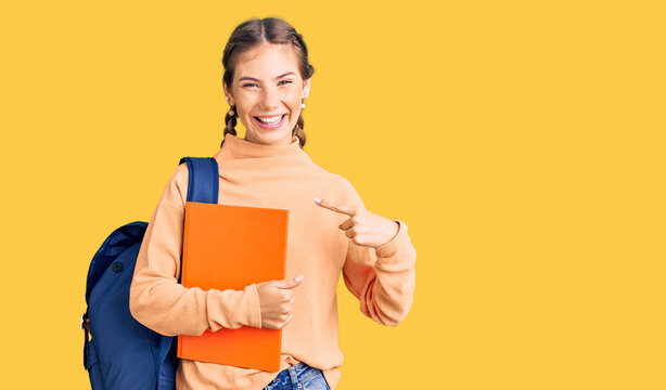 Beautiful caucasian woman with blonde hair wearing student backpack and holding book pointing finger to one self smiling happy and proud