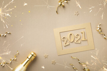 Christmas and New Year card with golden champagne bottle, confetti stars and 2021 numbers.