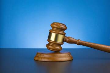 Wooden gavel on wooden surface, close up