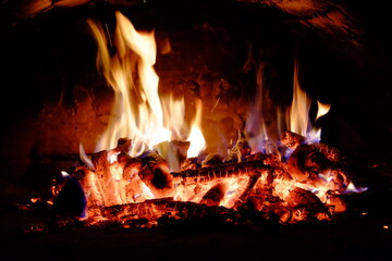 Logs burning in the oven. Flames and heat on the wood. Hot logs.