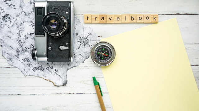 travel book.compass camera blank sheet of paper photo
