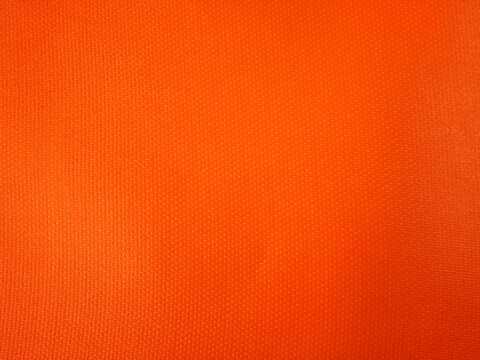 Abstract background made of bright orange fabric