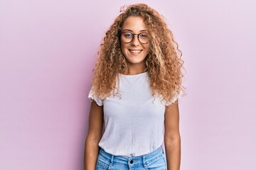 Beautiful caucasian teenager girl wearing white t-shirt over pink background with a happy and cool smile on face. lucky person.