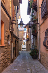 Narrow street in old town, Europe. Downtown in mountains, Spain. Facade of ancient houses. Historical cityscape. Empty town. Quarantine pause in Spain. Residential district with no people. Old centre.