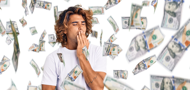 Young hispanic man wearing casual white tshirt bored yawning tired covering mouth with hand. restless and sleepiness.