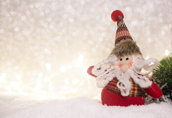 Happy toy santa claus standing in winter christmas background