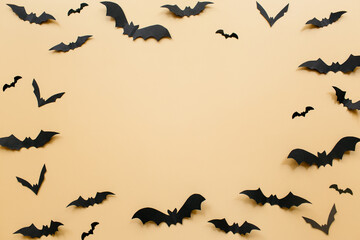 Halloween decorations with bats on pastel beige background. Halloween concept. Flat lay, top view, copy space