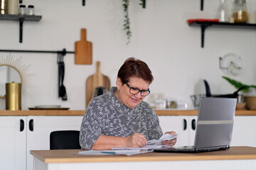 Old people, tax return and home banking. Worried senior lady paying federal taxes, doing family...