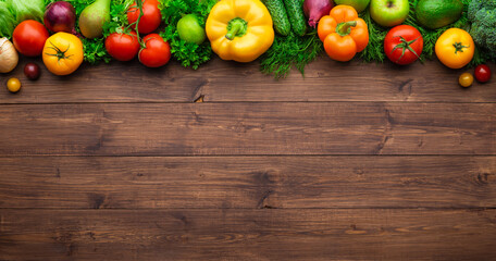 Healthy eating ingredients: fresh vegetables, fruits and superfood. Wooden background