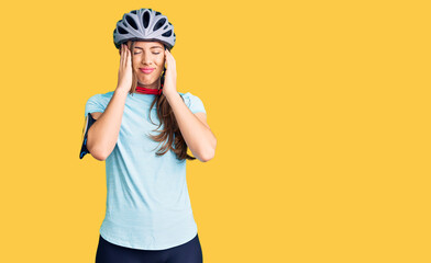 Beautiful caucasian young woman wearing bike helmet suffering from headache desperate and stressed because pain and migraine. hands on head.