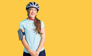 Beautiful caucasian young woman wearing bike helmet looking positive and happy standing and smiling with a confident smile showing teeth