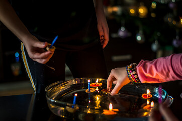 christmas traditional customs  - nut shell with burning candle floating on water