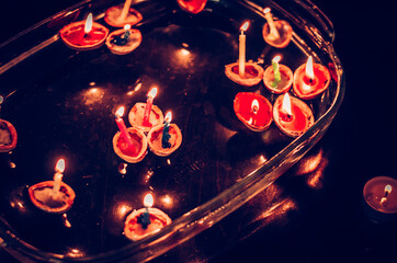 christmas traditional customs  - nut shell with burning candle floating on water