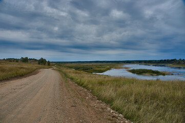 Forest dirt road in the wilderness along the river