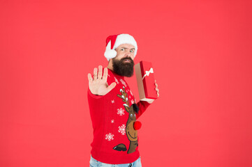 this box in mine. bearded man in santa hat and sweater. brutal hipster celebrate xmas party. winter holiday preparations. present shopping sale. happy new year. merry christmas. By golly, be jolly