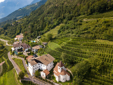 Aerial photo of the idyllic little church of St. Peter of Meran / Merano in south Tyrol, Italy along the Tappeiner path.