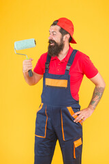 Tools for repair. painter at painting works. hipster change wall color. repair and building. craftsman on construction. creativity. master of reconstruction. happy bearded man with paint roller