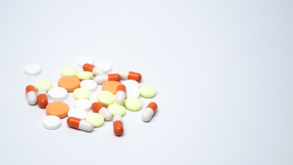 Pills and capsules close-up on white background