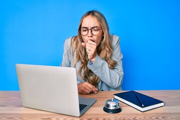 Young beautiful blonde woman sitting at hotel reception feeling unwell and coughing as symptom for cold or bronchitis. health care concept. - obrazy, fototapety, plakaty