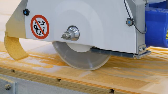 Automatic cnc 5 axis bridge circular saw - router profiling system cutting artificial stone at factory, exhibition. Industry, technology, production, equipment concept