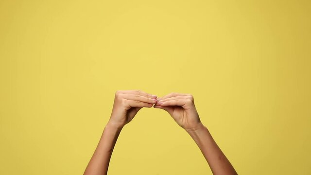 two hands talking and babbling on yellow background