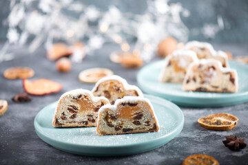 Christstollen, traditonal christmas cake with nuts, raisons, marzipan on a blue background, empty...