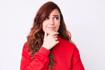 Young beautiful woman wearing casual clothes with hand on chin thinking about question, pensive expression. smiling with thoughtful face. doubt concept.