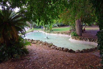 A fountain at Villa Sciarra city park of Rome in the autumn