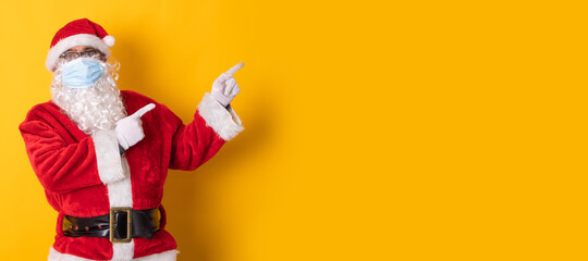 santa claus isolated on color background pointing to space