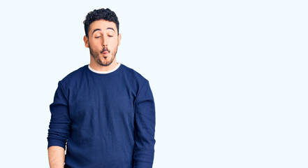 Young hispanic man wearing casual clothes making fish face with lips, crazy and comical gesture. funny expression.