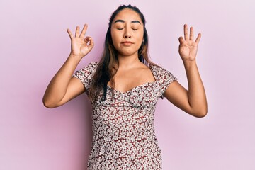 Young latin woman wearing casual clothes relax and smiling with eyes closed doing meditation gesture with fingers. yoga concept.