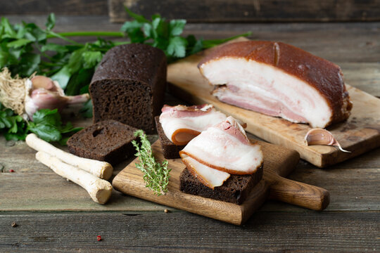 Smoked bacon on wooden background. Traditional Russian and Ukrainian food - salo.