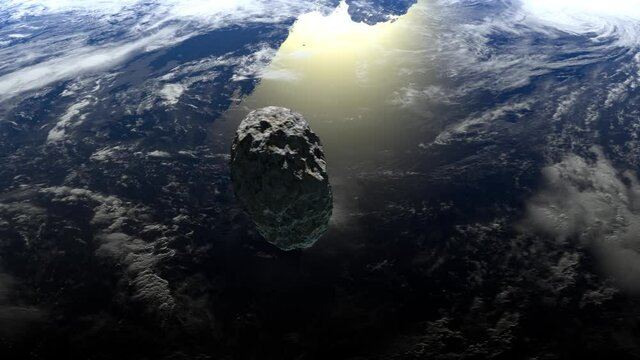 The asteroid flies over the Earth to the right and rotates slowly. 4K. 3d rendering.