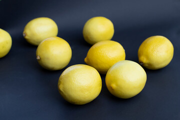 Lemons are sprinkled on a dark background