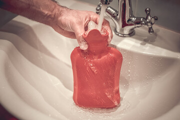 Fill a hot water bottle with warm water under the tap