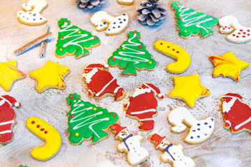 colorful Christmas homemade gingerbread cookies with snow background