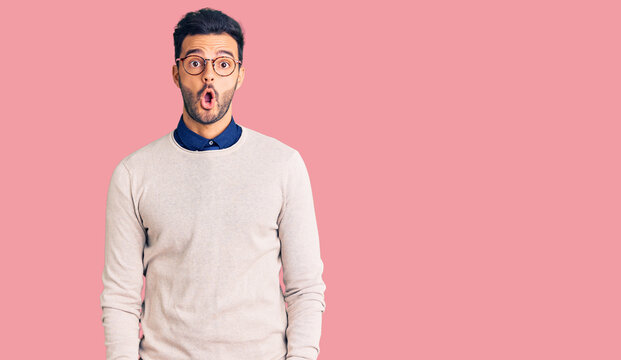 Young handsome hispanic man wearing elegant clothes and glasses afraid and shocked with surprise expression, fear and excited face.